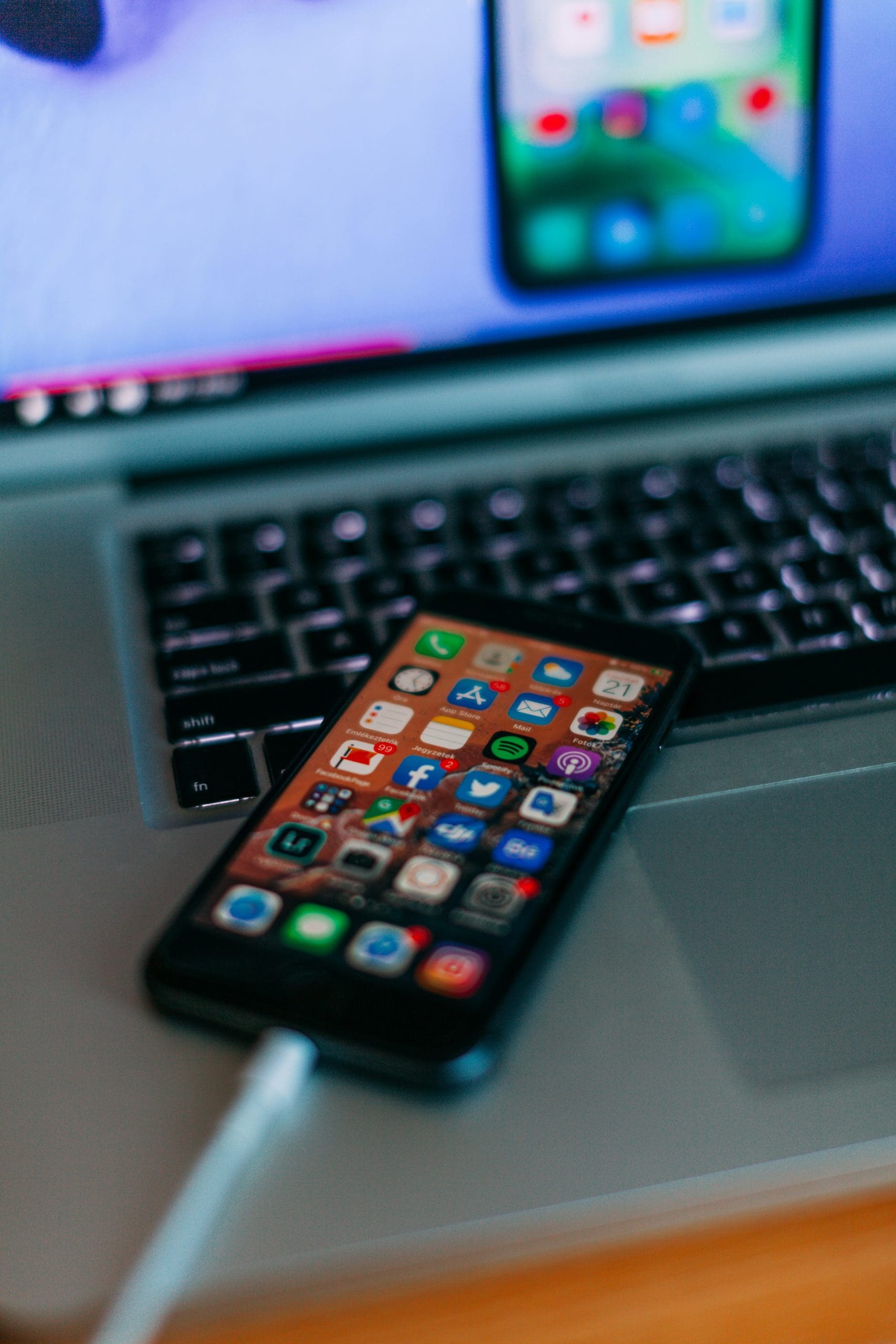 An unlocked phone on top of a open laptop